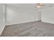 A spacious bedroom featuring neutral carpeting, a ceiling fan, and access to other rooms at 8011 Cavazzo Ave, Las Vegas, NV 89178