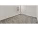 Bedroom with neutral carpeting with a window and a door at 8011 Cavazzo Ave, Las Vegas, NV 89178