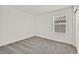 Bedroom with neutral carpeting featuring a window at 8011 Cavazzo Ave, Las Vegas, NV 89178
