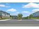 Street view of the gated community entrance with manicured landscaping and visible signage at 8011 Cavazzo Ave, Las Vegas, NV 89178