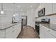 Bright eat-in kitchen with stainless steel appliances, granite countertops, tile backsplash and ample white cabinetry at 8011 Cavazzo Ave, Las Vegas, NV 89178