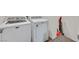 Laundry room with a white washing machine, a white dryer, and a red vacuum cleaner at 8011 Cavazzo Ave, Las Vegas, NV 89178