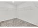 Empty walk-in closet with wire shelving and neutral carpeting, ready to be customized at 8011 Cavazzo Ave, Las Vegas, NV 89178