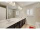 Bathroom featuring double sinks, white cabinets and granite counters at 8176 Duncan Peak Ct, Las Vegas, NV 89139