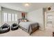 Bedroom with Queen bed, plush beanbag chairs, and light neutral color scheme with carpet flooring at 8176 Duncan Peak Ct, Las Vegas, NV 89139