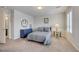 Bedroom with shutters, neutral carpet, and a bathroom entrance visible at 8176 Duncan Peak Ct, Las Vegas, NV 89139