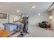 Bright bedroom featuring an open layout, sitting area, workout equipment, and neutral decor at 8176 Duncan Peak Ct, Las Vegas, NV 89139