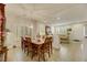 Dining room with seating for six, tiled floor, and modern lighting that opens to the living room at 8176 Duncan Peak Ct, Las Vegas, NV 89139