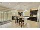 Open kitchen featuring an island with a marble countertop and dark cabinets at 8176 Duncan Peak Ct, Las Vegas, NV 89139