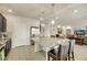 Open kitchen featuring large island with seating, stainless steel refrigerator, and dark cabinets at 8176 Duncan Peak Ct, Las Vegas, NV 89139