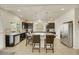 Bright kitchen with dark cabinets, stainless steel appliances, and large center island at 8176 Duncan Peak Ct, Las Vegas, NV 89139