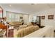 Living room with tiled floors, shutters, traditional furnishings, and a staircase nearby at 8176 Duncan Peak Ct, Las Vegas, NV 89139