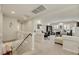 Second floor loft with carpet, bright lighting, two work areas, and a staircase leading to a dining room at 8176 Duncan Peak Ct, Las Vegas, NV 89139
