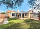 Inviting backyard features artificial grass, a covered patio with grill, and a charming swing at 8220 Desert Beach Dr, Las Vegas, NV 89128