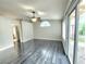Bright bedroom with hardwood floors, a ceiling fan, large windows, and sliding doors to the outside at 8220 Desert Beach Dr, Las Vegas, NV 89128