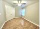 Bedroom featuring wood floors, a ceiling fan, window and large closet at 8220 Desert Beach Dr, Las Vegas, NV 89128