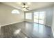 Inviting bedroom with hardwood flooring, a ceiling fan, and sliding glass doors leading to the backyard at 8220 Desert Beach Dr, Las Vegas, NV 89128