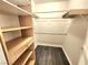 Walk-in closet featuring custom shelving and hardwood floors at 8220 Desert Beach Dr, Las Vegas, NV 89128