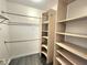 Walk-in closet featuring custom shelving and hardwood floors at 8220 Desert Beach Dr, Las Vegas, NV 89128