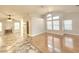 Bright and airy living room with hardwood flooring, neutral walls, large windows, and a fireplace at 8220 Desert Beach Dr, Las Vegas, NV 89128