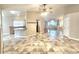 Spacious living area with tile flooring, flowing into an open kitchen and light colored walls at 8220 Desert Beach Dr, Las Vegas, NV 89128