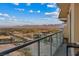 Balcony showcasing panoramic views of the city and mountains under a partly cloudy, blue sky at 8255 Las Vegas Blvd # 1905, Las Vegas, NV 89123