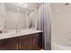Bathroom featuring a shower-tub combo with shower curtain and a sleek vanity at 8255 Las Vegas Blvd # 1905, Las Vegas, NV 89123