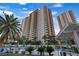 Beautiful condo building with a resort style pool, palm trees, and ample outdoor seating at 8255 Las Vegas Blvd # 1905, Las Vegas, NV 89123