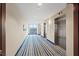 Hallway with blue striped carpet leading to elevators and a view of the city at 8255 Las Vegas Blvd # 1905, Las Vegas, NV 89123