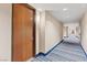 Hallway with doors and striped blue carpet with an apartment number at 8255 Las Vegas Blvd # 1905, Las Vegas, NV 89123