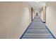 Apartment hallway with doors and striped blue carpet at 8255 Las Vegas Blvd # 1905, Las Vegas, NV 89123