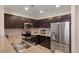 A well-equipped kitchen with stainless steel appliances, stone backsplash, and dark wood cabinetry at 8255 Las Vegas Blvd # 1905, Las Vegas, NV 89123