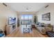 Inviting living room with hardwood floors and sliding glass doors leading to a balcony at 8255 Las Vegas Blvd # 1905, Las Vegas, NV 89123