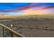 Balcony with night view of city lights and a colorful sunset over the horizon with highway and desert scenery at 8255 Las Vegas Blvd # 1905, Las Vegas, NV 89123