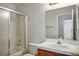 Bright bathroom featuring a tiled vanity, large mirror, a tub with shower, and a toilet at 901 Nevada Sky St, Las Vegas, NV 89128