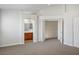 This carpeted bedroom includes an ensuite bathroom and an open doorway to a hallway at 901 Nevada Sky St, Las Vegas, NV 89128