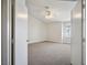 Bedroom features neutral carpet, a ceiling fan, and bright light from a window with blinds at 901 Nevada Sky St, Las Vegas, NV 89128