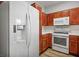 Modern kitchen boasting stainless steel refrigerator, wood cabinets, and sleek appliances, creating a contemporary culinary experience at 901 Nevada Sky St, Las Vegas, NV 89128