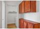 A laundry room with washer and dryer hookups, with wood look floors, and built in wooden cabinets at 901 Nevada Sky St, Las Vegas, NV 89128
