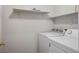 A bright laundry room featuring a washer and dryer and shelving for extra storage at 901 Nevada Sky St, Las Vegas, NV 89128
