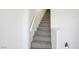 Interior shot of carpeted stairs with white walls, leading to the upper level, offering a transition between floors at 901 Nevada Sky St, Las Vegas, NV 89128