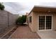 Property backyard featuring desert landscape, a retaining wall planter, and access to home and side yard at 904 Swift Bear St, Henderson, NV 89002