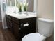 Bathroom featuring a double sink vanity, dark wood cabinets, and a toilet at 904 Swift Bear St, Henderson, NV 89002