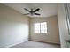 Bedroom with neutral color walls and carpet and a window providing natural light to the room at 904 Swift Bear St, Henderson, NV 89002