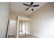 This bedroom features mirrored closet doors, a ceiling fan and neutral carpeting at 904 Swift Bear St, Henderson, NV 89002