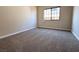 Cozy bedroom with neutral carpet, a window for natural light, and ample space at 904 Swift Bear St, Henderson, NV 89002