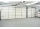Spacious garage featuring epoxy flooring and plenty of room for storage at 904 Swift Bear St, Henderson, NV 89002