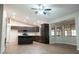 Open concept kitchen with dark cabinets, stainless steel appliances, an island, and plenty of natural light at 904 Swift Bear St, Henderson, NV 89002