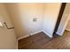 This laundry area features wood-look flooring and modern hookups at 904 Swift Bear St, Henderson, NV 89002