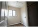 Small laundry room with a window for light and dark wood cabinets at 904 Swift Bear St, Henderson, NV 89002